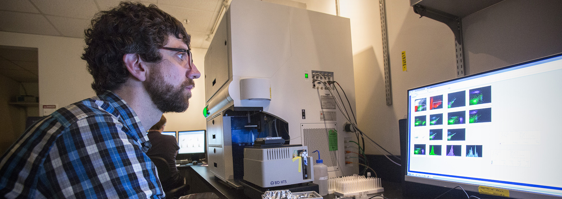 A scientist runs samples on a flow cytometer  in the Boeckh Lab