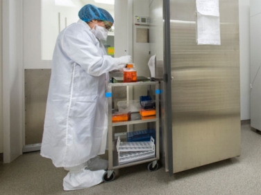 Researcher working in a cell processing facility