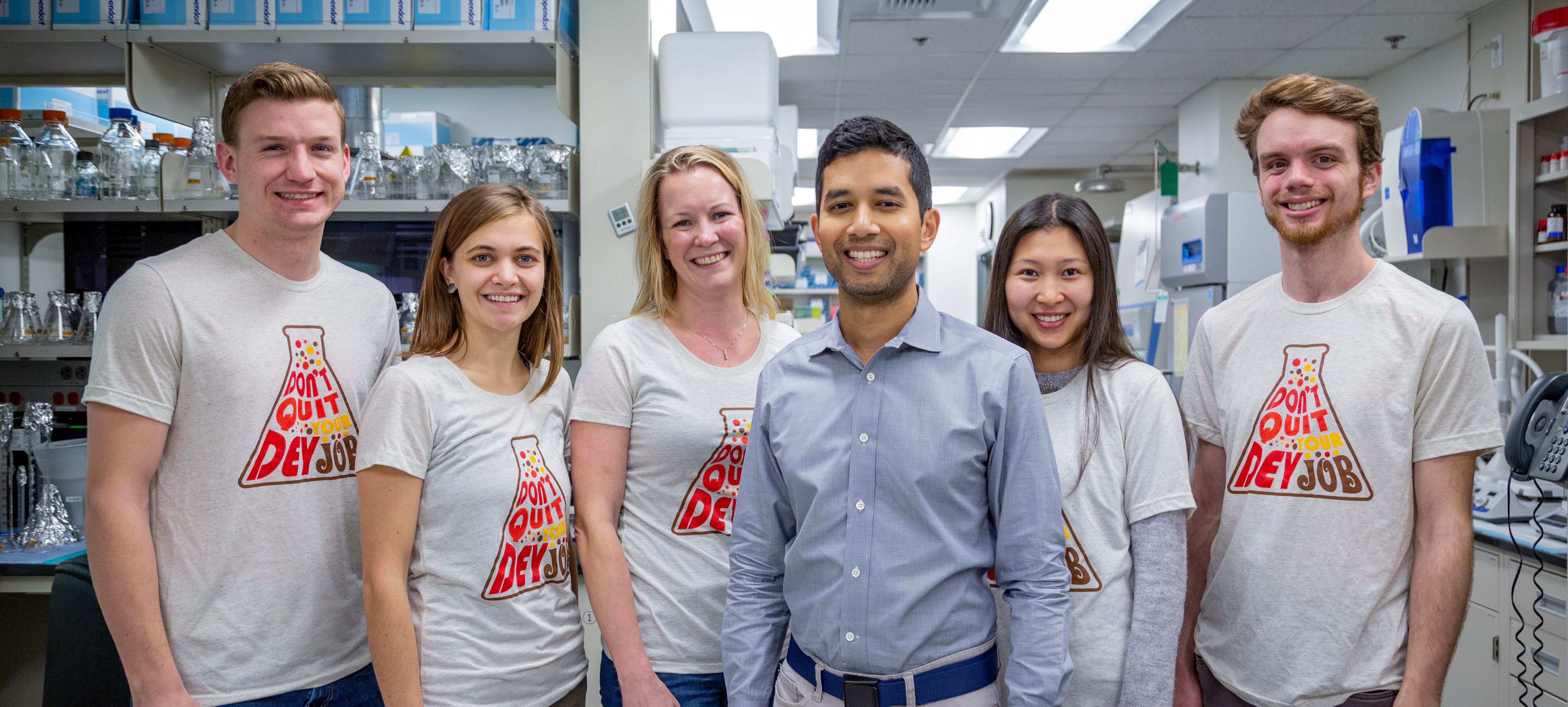 Photo of Dr. Dey with his five lab members in the lab