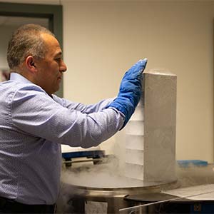 Dr. Soheil Meshinchi removes samples from a cryogenic freezer