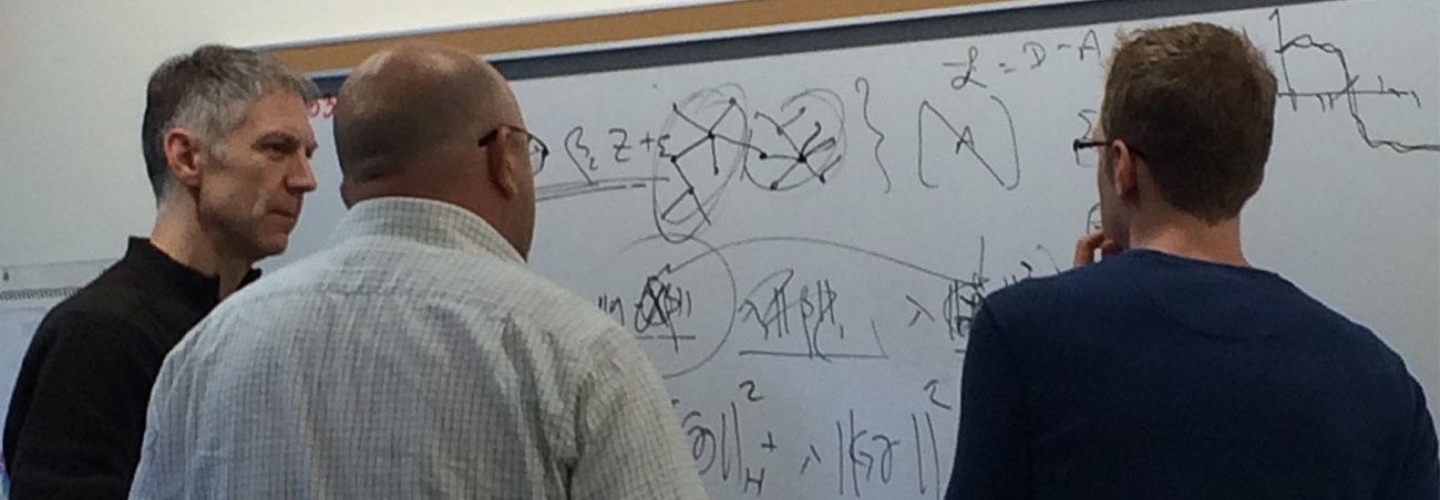 Image of Tim Randolph and colleagues at a white board