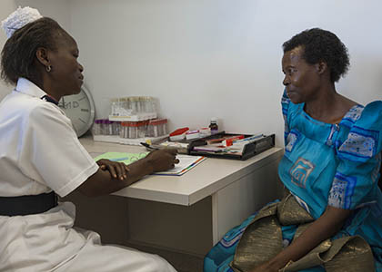 A nurse talks with a patient